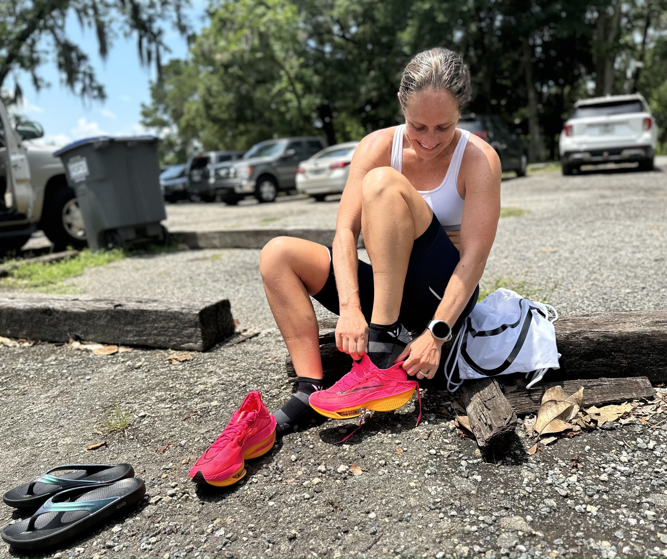a female triathlete putting on her shoes to go for a brick run