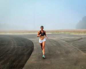 A female runner in the fog