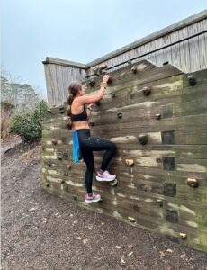 a women climbing a rock wall