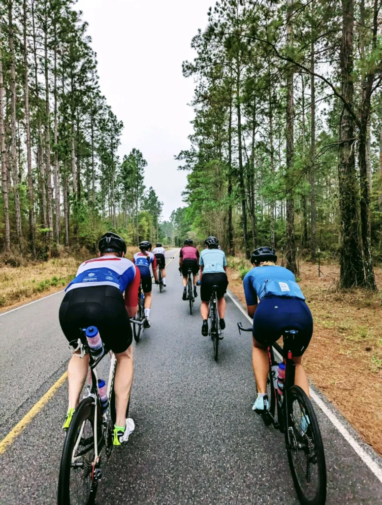 A group of cyclist riding in two rows.