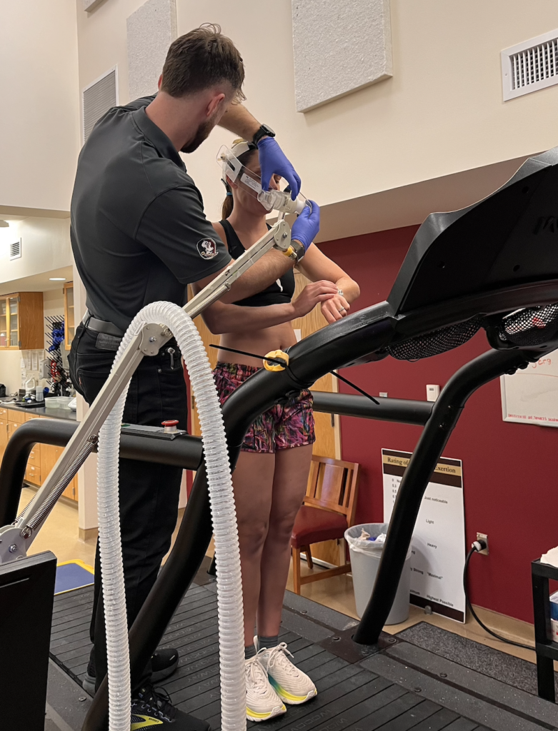 a female runner puts on a mask for vo2 max testing