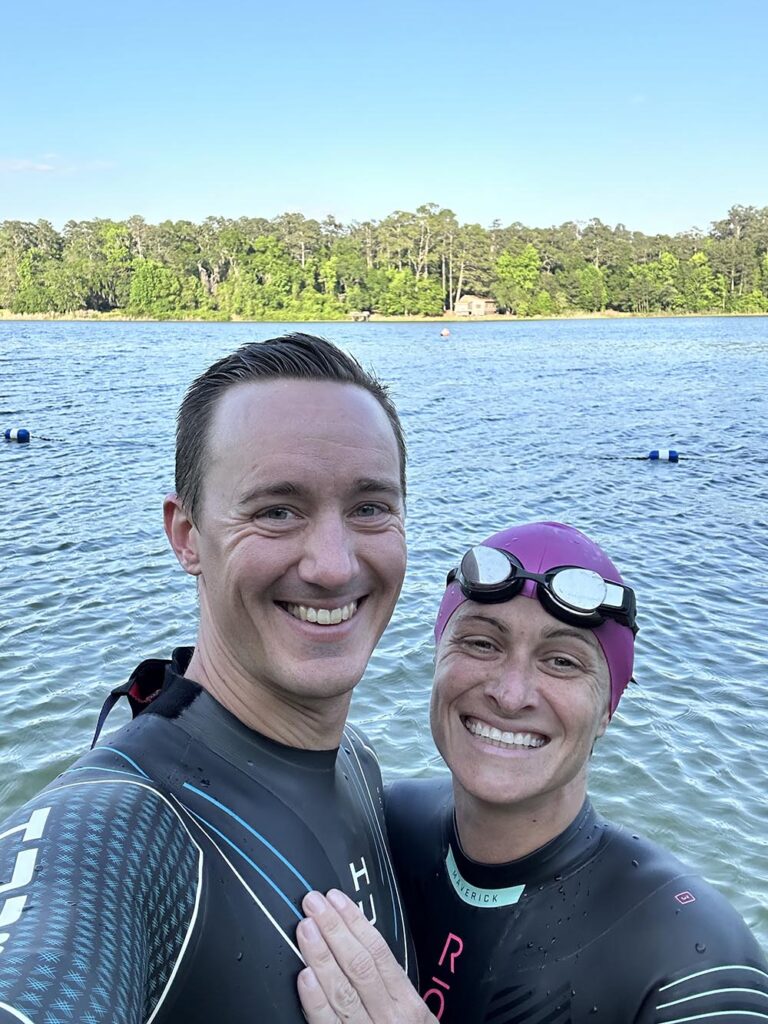 two triathletes getting ready to open water swim