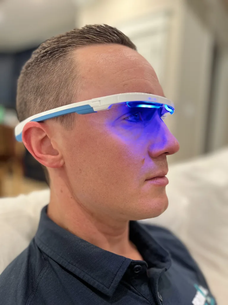 A man wearing blue light therapy glasses.