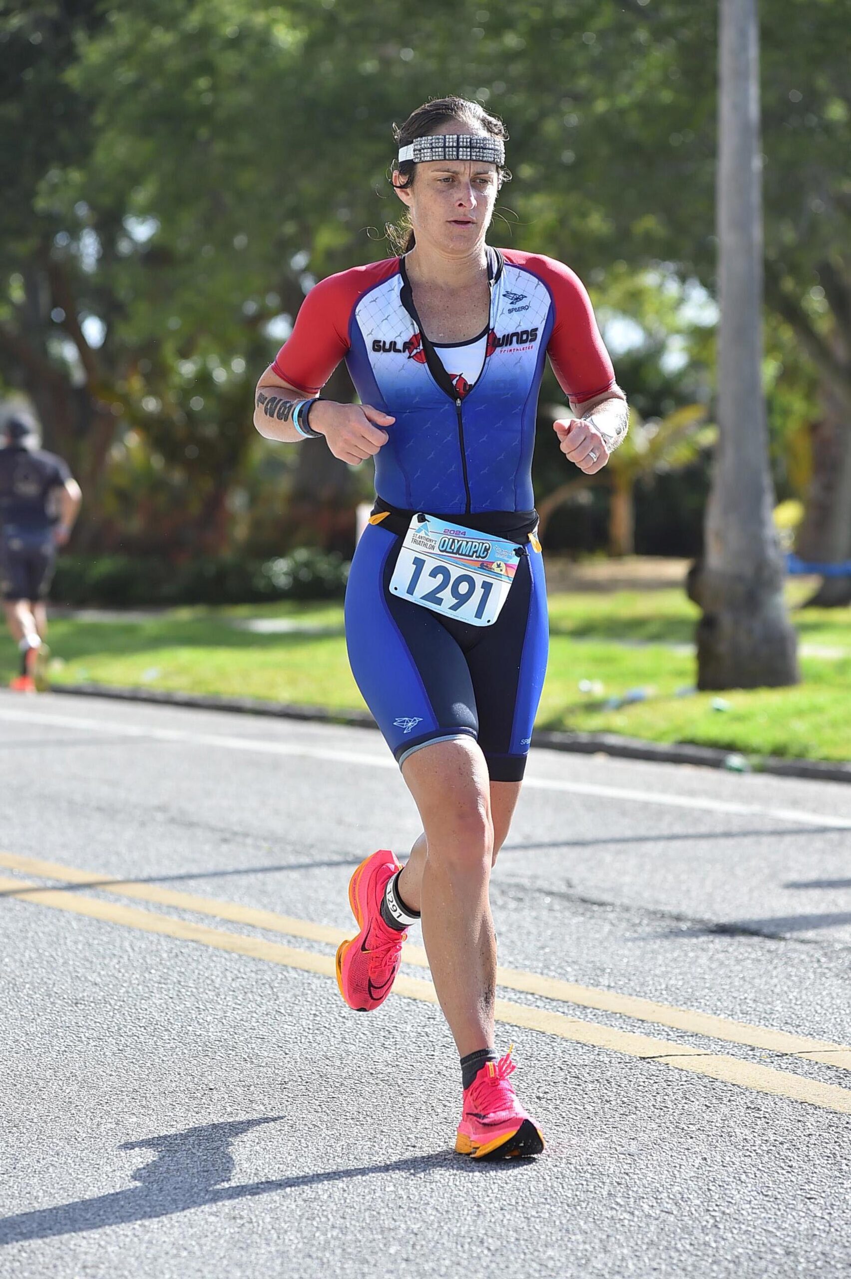 A woman running in a triathlon.